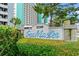 Close-up of the SeaMaster building sign with lush greenery and nautical details at 1310 N Waccamaw Dr. # 204, Garden City Beach, SC 29576