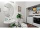 A powder room featuring a pedestal sink, toilet, and stackable washer and dryer at 160 Cart Crossing Dr. # 104, Conway, SC 29526