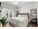 Bright bedroom featuring hardwood floors, a comfortable bed, and abundant natural light from large windows at 160 Cart Crossing Dr. # 104, Conway, SC 29526