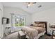 Primary bedroom featuring a queen bed, a window, and a mounted television at 160 Cart Crossing Dr. # 104, Conway, SC 29526