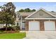Charming home featuring a two-car garage, manicured lawn, and mature landscaping at 160 Cart Crossing Dr. # 104, Conway, SC 29526
