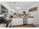 This well-lit kitchen is adorned with greenery and features modern appliances and classic white cabinetry at 160 Cart Crossing Dr. # 104, Conway, SC 29526