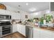 Well-lit kitchen featuring stainless steel appliances, white cabinets, and a variety of charming decor at 160 Cart Crossing Dr. # 104, Conway, SC 29526