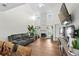 Bright living room featuring a vaulted ceiling, fireplace, and access to the outdoor space at 160 Cart Crossing Dr. # 104, Conway, SC 29526