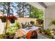 Charming patio area with stylish furniture, patterned rug, and a variety of potted plants creating a peaceful retreat at 160 Cart Crossing Dr. # 104, Conway, SC 29526