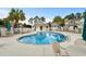 Community pool surrounded by tables, chairs, and lush landscaping for relaxation and recreation at 160 Cart Crossing Dr. # 104, Conway, SC 29526