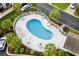 Aerial view of the community pool surrounded by lounge seating, tables, and landscaping at 160 Cart Crossing Dr. # 104, Conway, SC 29526