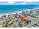 Scenic aerial shot of beach community with a blue house, coastline, and distant pier at 163 Cypress Ave., Murrells Inlet, SC 29576