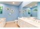 Bright bathroom with a double sink vanity, a large mirror and beautiful, beach-themed decor at 163 Cypress Ave., Murrells Inlet, SC 29576