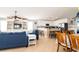 Bright living room with a built-in entertainment center, kitchen with bar seating, and comfortable blue sofa at 163 Cypress Ave., Murrells Inlet, SC 29576
