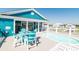 Relaxing pool deck features a splash pool and stylish blue outdoor seating with a table and white chairs at 163 Cypress Ave., Murrells Inlet, SC 29576