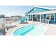 The upper deck of this beach house offers a serene lounging area with a pool and stylish blue outdoor seating at 163 Cypress Ave., Murrells Inlet, SC 29576