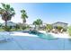Beautiful outdoor pool area with lounge chairs, palm trees, and attractive landscaping at 163 Cypress Ave., Murrells Inlet, SC 29576