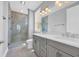 Elegant bathroom featuring a marble walk-in shower and double vanity with modern lighting at 1957 Indigo Cove Ln, Calabash, NC 28467