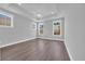Bright bedroom featuring tray ceilings, recessed lighting, three windows and wood look floors at 1957 Indigo Cove Ln, Calabash, NC 28467