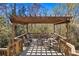 Open deck with a pergola overhead featuring lots of seating and a fire pit for enjoying the outdoors at 1957 Indigo Cove Ln, Calabash, NC 28467
