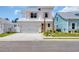 Charming two-story home featuring a light-colored exterior, lush landscaping and a two car garage at 1957 Indigo Cove Ln, Calabash, NC 28467