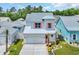 Charming two-story home featuring a white exterior, light blue roof, a garage and landscaping at 1957 Indigo Cove Ln, Calabash, NC 28467