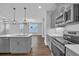 Stylish kitchen featuring pendant lights, modern appliances, and a seamless transition into the living area at 1957 Indigo Cove Ln, Calabash, NC 28467