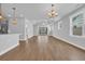 Spacious living room boasts recessed lighting, wood floors, a modern ceiling fan and abundant natural light at 1957 Indigo Cove Ln, Calabash, NC 28467