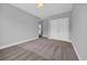 Bedroom featuring neutral carpeting and paint, with double doors and hallway access at 1961 Indigo Cove Ln, Calabash, NC 28467