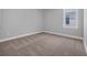 Bedroom with neutral carpeting and paint, with a window providing natural light at 1961 Indigo Cove Ln, Calabash, NC 28467