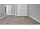 Bedroom featuring neutral carpet and paint with double doors and hallway access at 1961 Indigo Cove Ln, Calabash, NC 28467