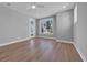 Bright bedroom featuring hardwood floors, modern ceiling fan, and a door to outdoor space at 1961 Indigo Cove Ln, Calabash, NC 28467