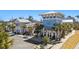 A bright and airy clubhouse with palm trees, outdoor seating, and a large parking area at 1961 Indigo Cove Ln, Calabash, NC 28467