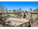 Expansive wooden deck area with multiple levels, seating, and views of the pool and community buildings at 1961 Indigo Cove Ln, Calabash, NC 28467