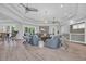 A spacious and inviting living room with modern furniture, wood floors, and plenty of natural light at 1961 Indigo Cove Ln, Calabash, NC 28467