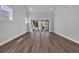 Bright and airy living room featuring luxury vinyl plank flooring and sliding doors to the backyard at 1961 Indigo Cove Ln, Calabash, NC 28467