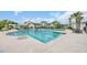 Luxurious outdoor pool area with ample seating, palm trees, and clear blue water, perfect for relaxation at 1961 Indigo Cove Ln, Calabash, NC 28467