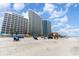 Oceanfront resort with high-rise condos, sandy beach, and blue umbrellas at 201 S Ocean Blvd. # 1112, Myrtle Beach, SC 29577