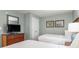 Bedroom showcasing two beds, tv with dresser, and beach themed wall decor at 201 S Ocean Blvd. # 1112, Myrtle Beach, SC 29577
