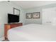 Comfortable bedroom with a flat-screen TV, light-green walls, and beach themed pictures at 201 S Ocean Blvd. # 1112, Myrtle Beach, SC 29577