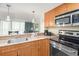 This kitchen features wood cabinets, granite counters, and stainless oven and microwave at 201 S Ocean Blvd. # 1112, Myrtle Beach, SC 29577