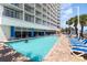 Outdoor pool area surrounded by lounge chairs for relaxation at 201 S Ocean Blvd. # 1112, Myrtle Beach, SC 29577
