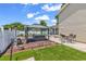 Landscaped backyard with gazebo-covered hot tub, outdoor seating, and manicured synthetic grass at 2017 Chadbury Ln., Myrtle Beach, SC 29588