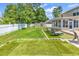 Lush backyard featuring synthetic grass, lounge chairs, and storage sheds behind a white fence at 2017 Chadbury Ln., Myrtle Beach, SC 29588