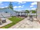 A well-manicured backyard featuring pavers, synthetic grass, a gazebo with a hot tub, and a white fence at 2017 Chadbury Ln., Myrtle Beach, SC 29588