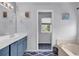 Bright bathroom features a blue vanity with white countertop and a view into another room at 2017 Chadbury Ln., Myrtle Beach, SC 29588