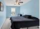 Blue bedroom featuring neutral carpet, a black bedspread, and natural light from the window at 2017 Chadbury Ln., Myrtle Beach, SC 29588