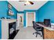 Bright blue bedroom with a fireplace, a desk, and walk-in closet at 2017 Chadbury Ln., Myrtle Beach, SC 29588