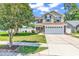 Charming two-story home featuring a manicured lawn and a two-car garage on a sunny day at 2017 Chadbury Ln., Myrtle Beach, SC 29588