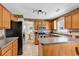 Well-lit kitchen featuring wood cabinets, tile floors, and stainless steel appliances at 2017 Chadbury Ln., Myrtle Beach, SC 29588