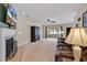 Cozy living room with a fireplace, ceiling fan, and sliding glass doors to a sunroom at 2017 Chadbury Ln., Myrtle Beach, SC 29588