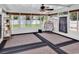Bright sunroom with large windows, neutral carpet, and an egg chair at 2017 Chadbury Ln., Myrtle Beach, SC 29588