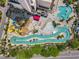 Aerial view of a resort featuring a waterpark with slides, a lazy river, and pools surrounded by lush landscaping at 202 74Th Ave. N # 2547/2548, Myrtle Beach, SC 29572