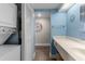 Bathroom featuring a light blue wall, white vanity with a single sink, and access to the laundry area at 202 74Th Ave. N # 2547/2548, Myrtle Beach, SC 29572